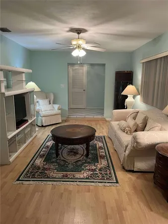 a living room with furniture a chandelier and a fireplace