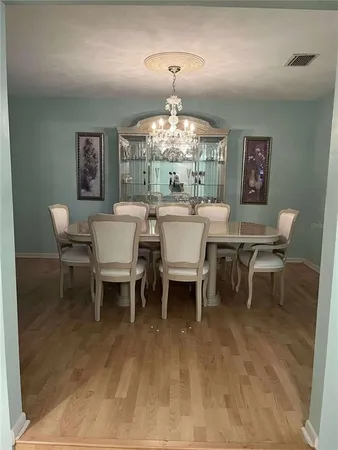 a dining room with a wooden table and chairs