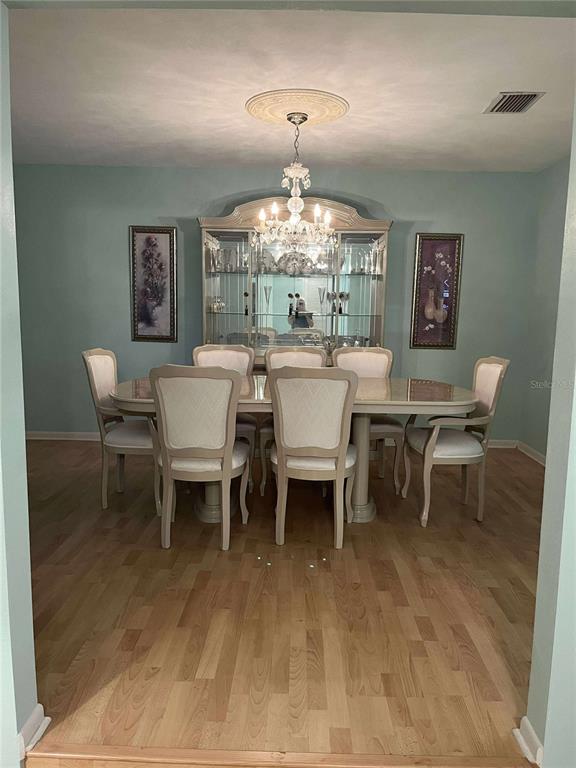 608 Knowles Road Brandon, FL 33511 - Photo 6 of 41 a dining room with a wooden table and chairs