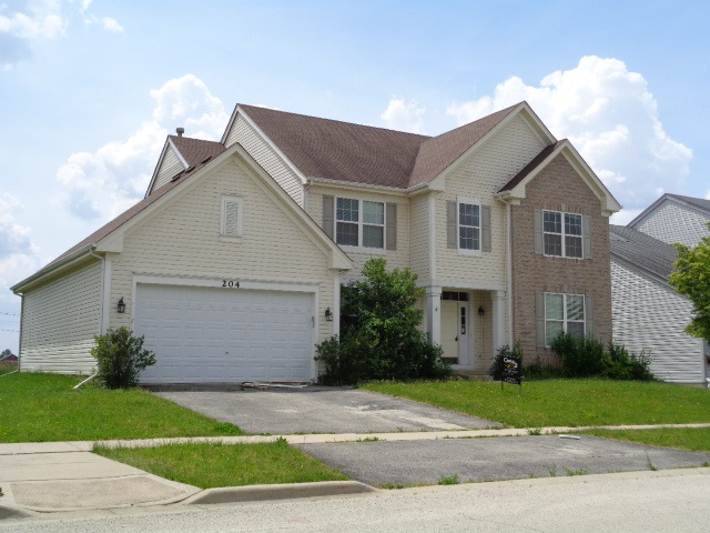 204 Wilkins Road Sycamore, IL 60178 - Photo 1 of 24 a view of a white house with a yard and plants