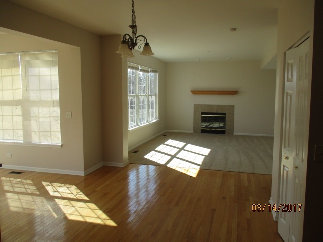 204 Wilkins Road Sycamore, IL 60178 - Photo 11 of 24 a view of an empty room with window and wooden floor