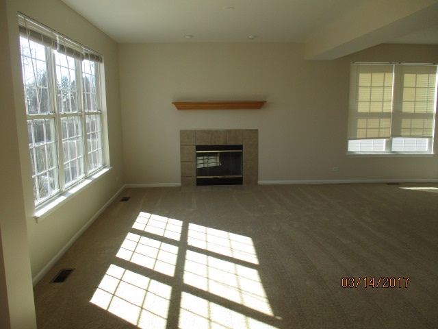 204 Wilkins Road Sycamore, IL 60178 - Photo 12 of 24 a view of an empty room with a window and fire place
