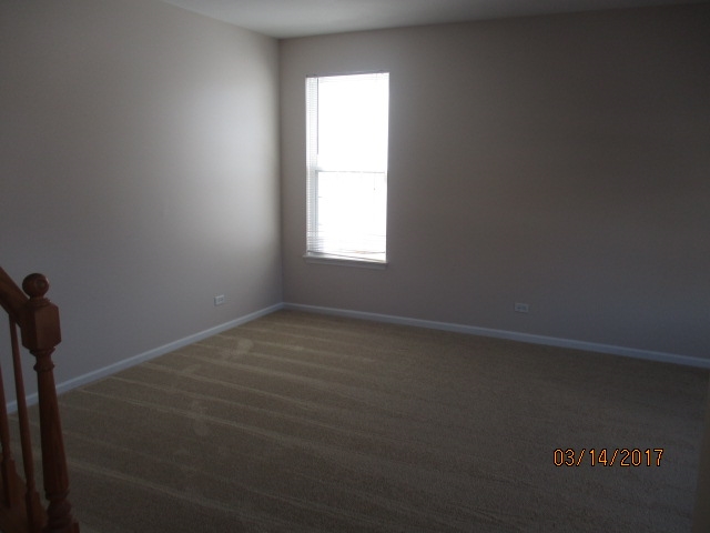 204 Wilkins Road Sycamore, IL 60178 - Photo 4 of 24 an empty room with a window
