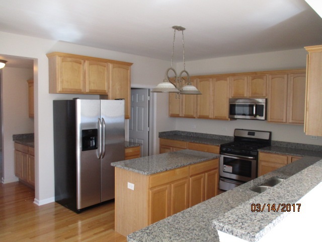 204 Wilkins Road Sycamore, IL 60178 - Photo 8 of 24 a kitchen with stainless steel appliances granite countertop a refrigerator a stove a sink and a microwave