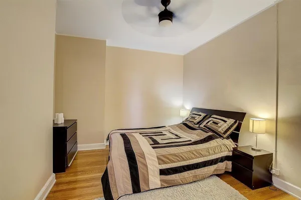a bedroom with a bed and a cabinet