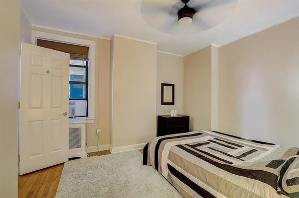 a bedroom with a bed and cabinets