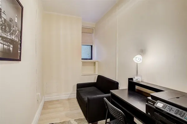 a living room with a piano and a flat screen tv