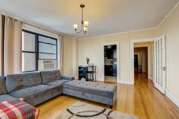 a living room with furniture and a chandelier