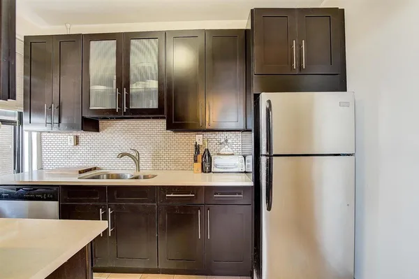 a kitchen with a refrigerator and a sink
