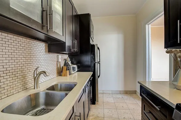 a kitchen with a sink cabinets and a refrigerator