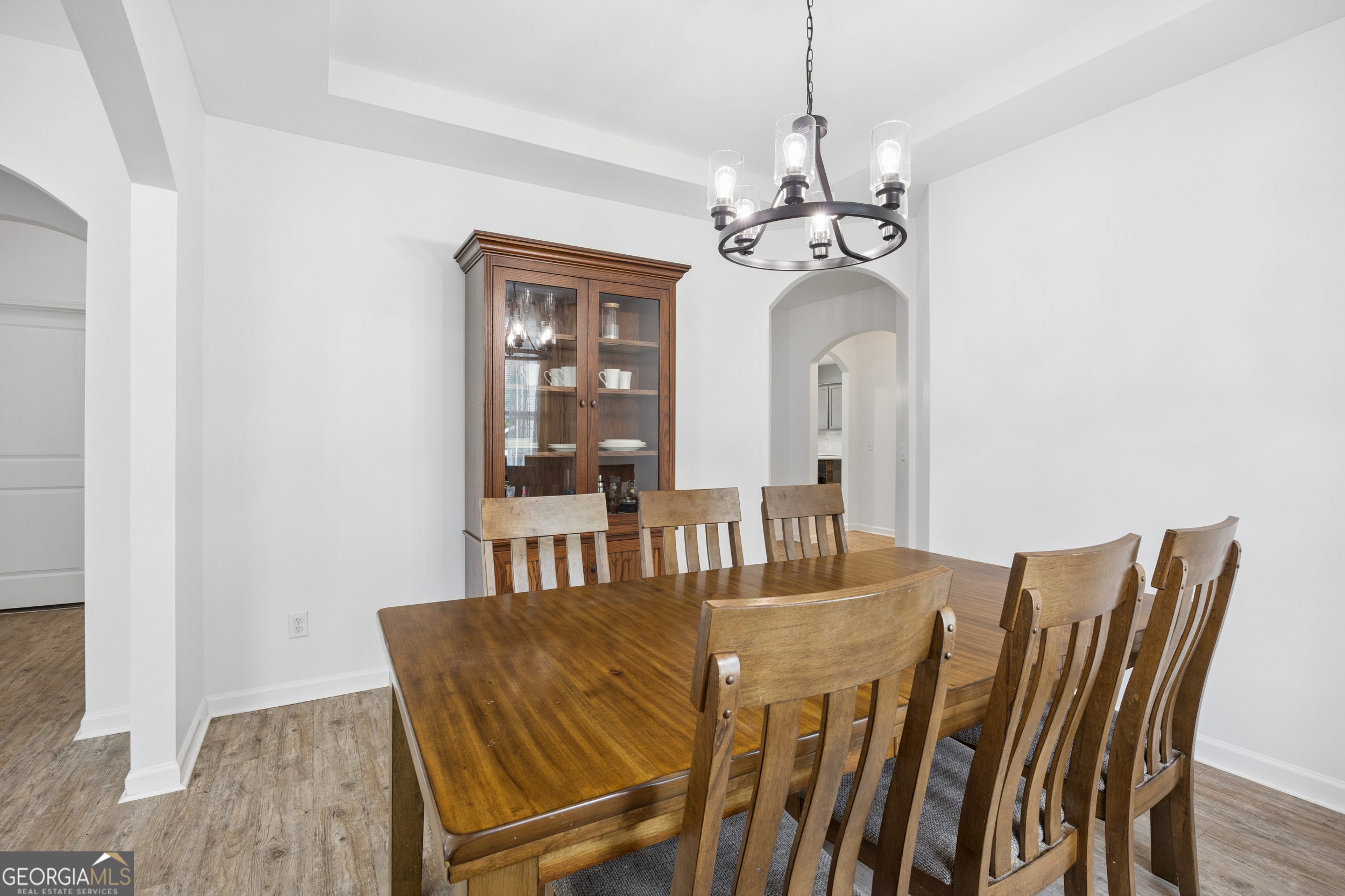 369 Waybridge Way Richmond Hill, GA 31324 - Photo 23 of 40 a view of a dining room with furniture and a chandelier
