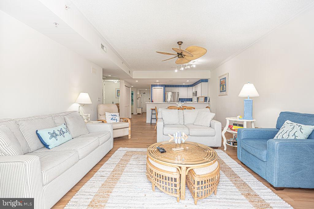 9 90th Street, Unit 102 Ocean City, MD 21842 - Photo 13 of 42 a living room with furniture and a chandelier