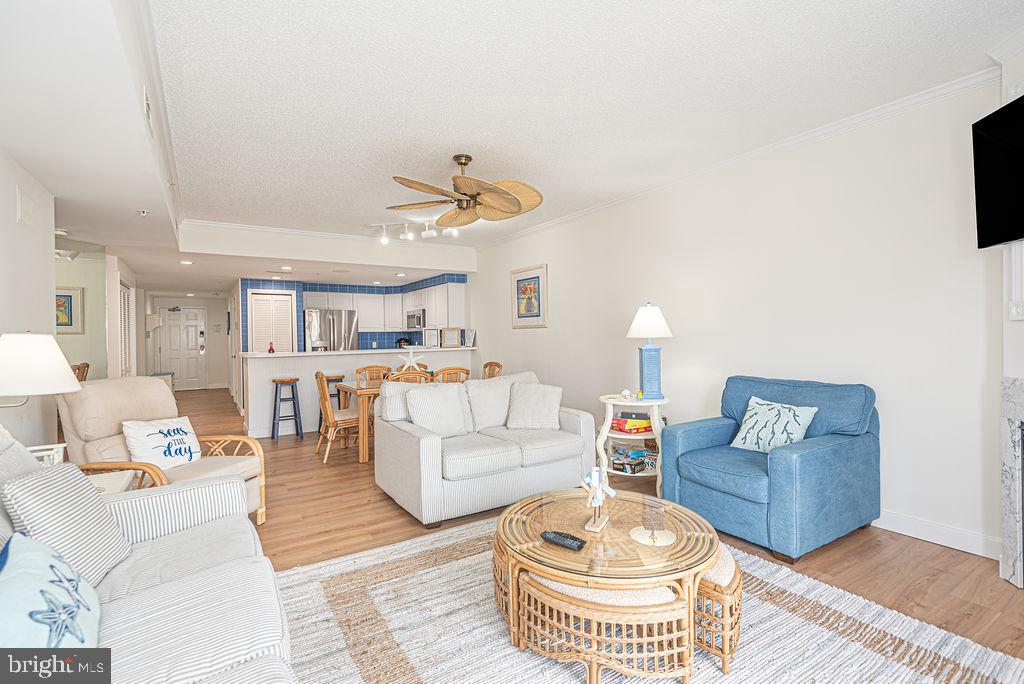 9 90th Street, Unit 102 Ocean City, MD 21842 - Photo 14 of 42 a living room with furniture and a chandelier