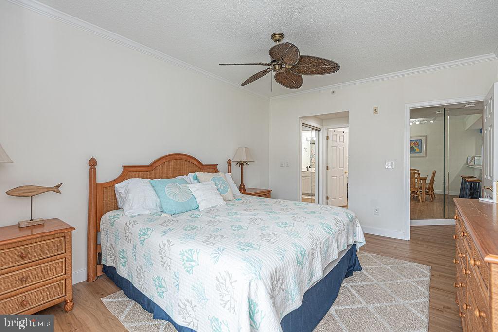 9 90th Street, Unit 102 Ocean City, MD 21842 - Photo 21 of 42 a bedroom with a bed and a chandelier
