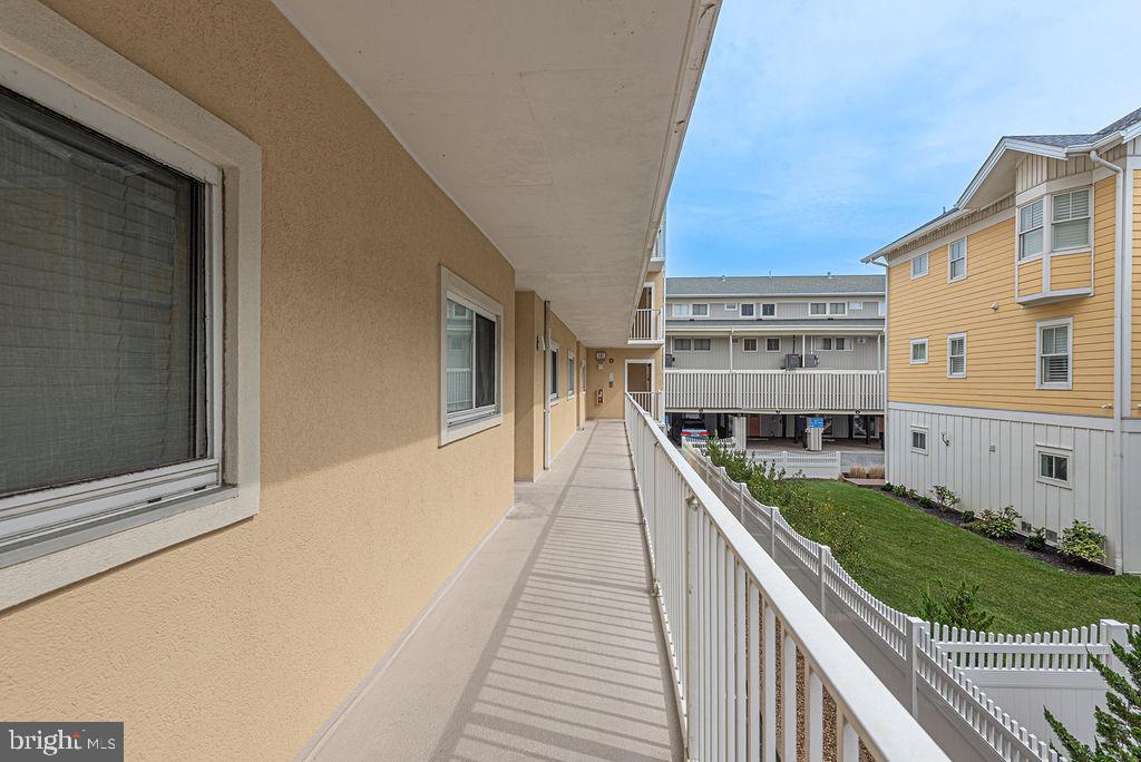 9 90th Street, Unit 102 Ocean City, MD 21842 - Photo 3 of 42 a view of balcony with two chairs and a yard