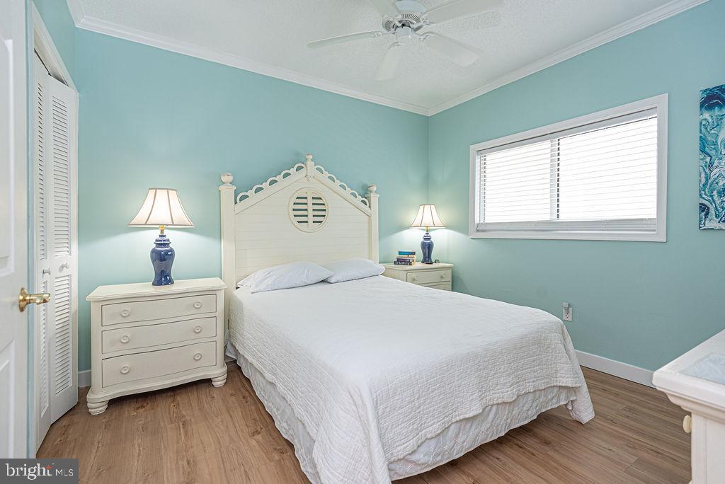 9 90th Street, Unit 102 Ocean City, MD 21842 - Photo 31 of 42 a bedroom with a bed and a window