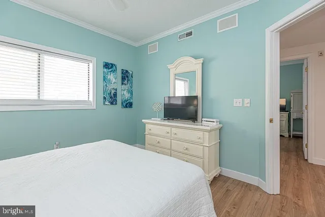 a bedroom with a bed and a flat tv screen in it
