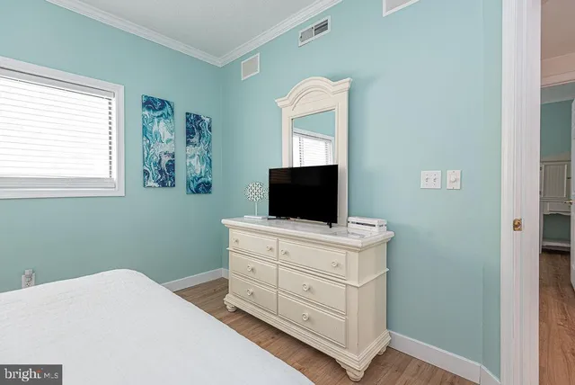 a bedroom with a bed and a television