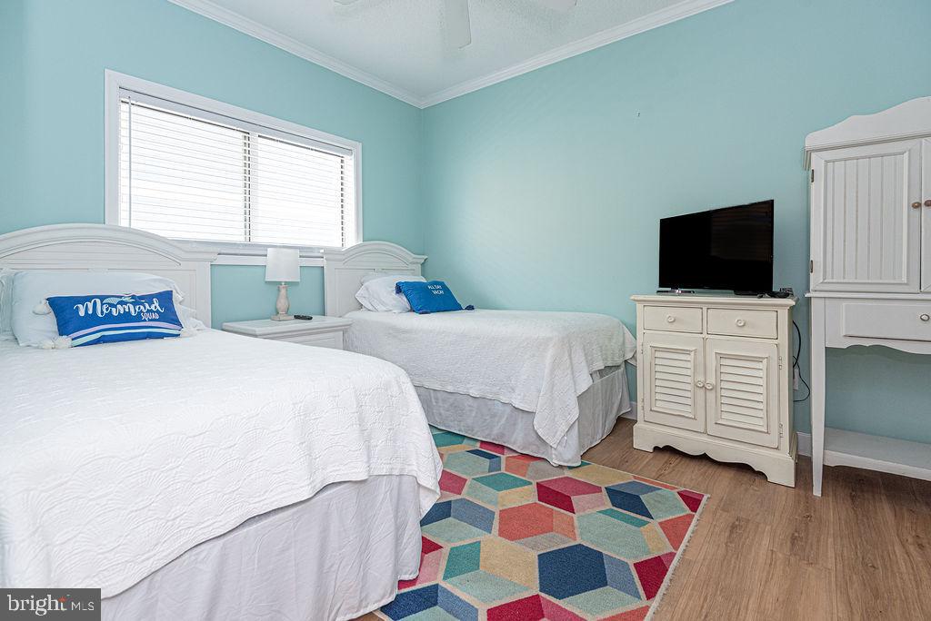 9 90th Street, Unit 102 Ocean City, MD 21842 - Photo 34 of 42 a bedroom with a bed and a television