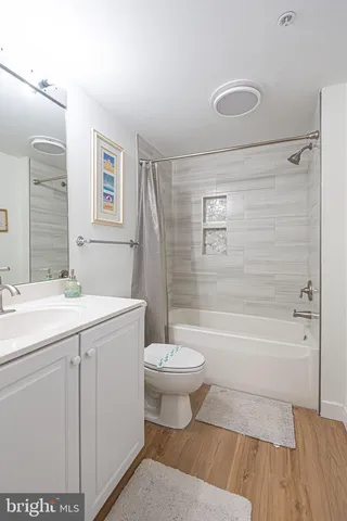 a utility room with dryer washer and a view of living area