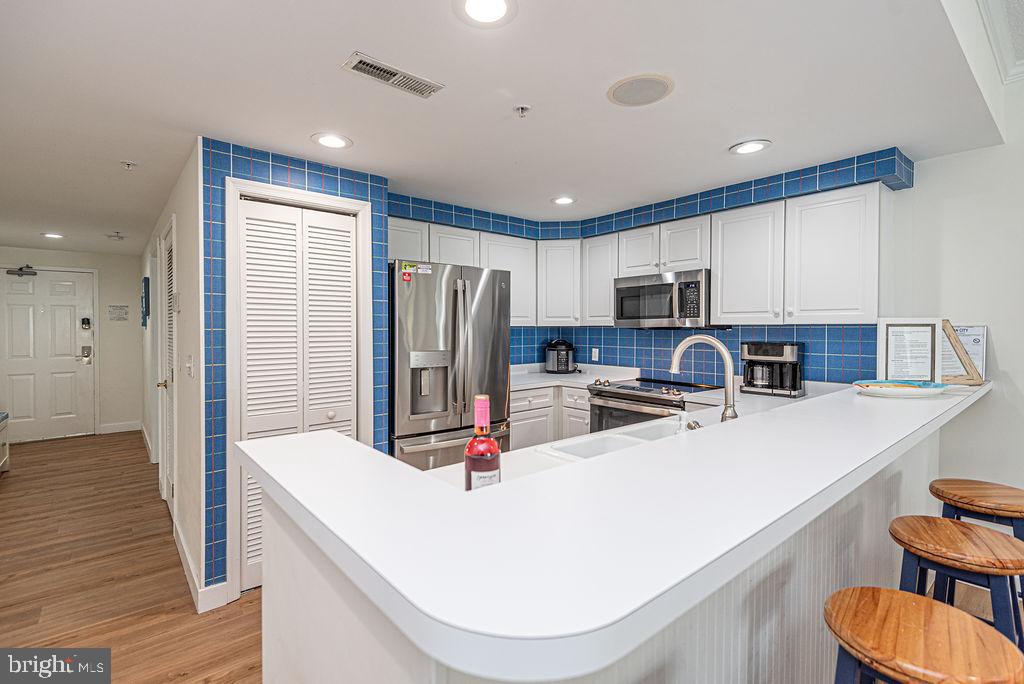 9 90th Street, Unit 102 Ocean City, MD 21842 - Photo 8 of 42 a kitchen with stainless steel appliances a refrigerator and a stove top oven