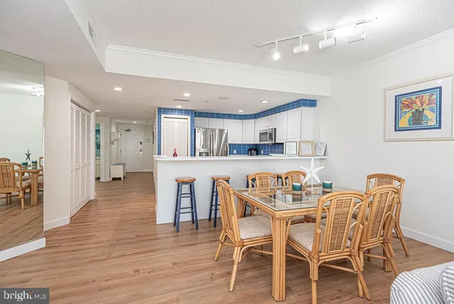 a dining room with furniture and wooden floor