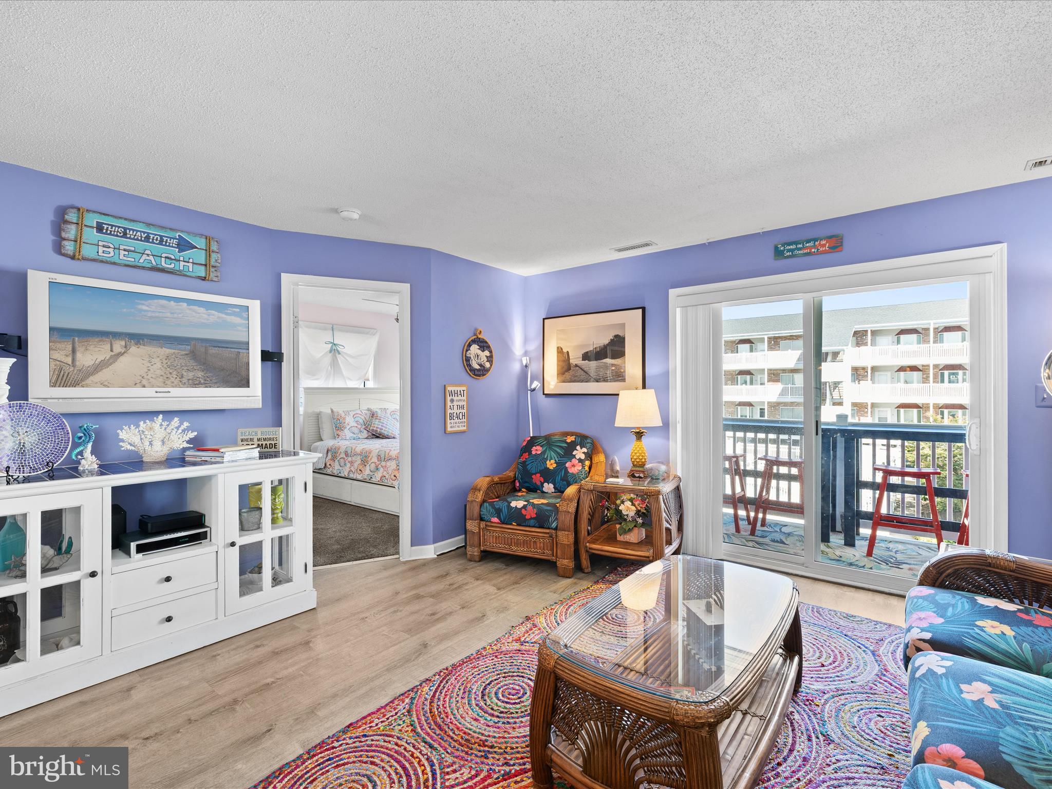 5500 Coastal Highway, Unit B23003 Ocean City, MD 21842 - Photo 11 of 26 a living room with furniture and a flat screen tv