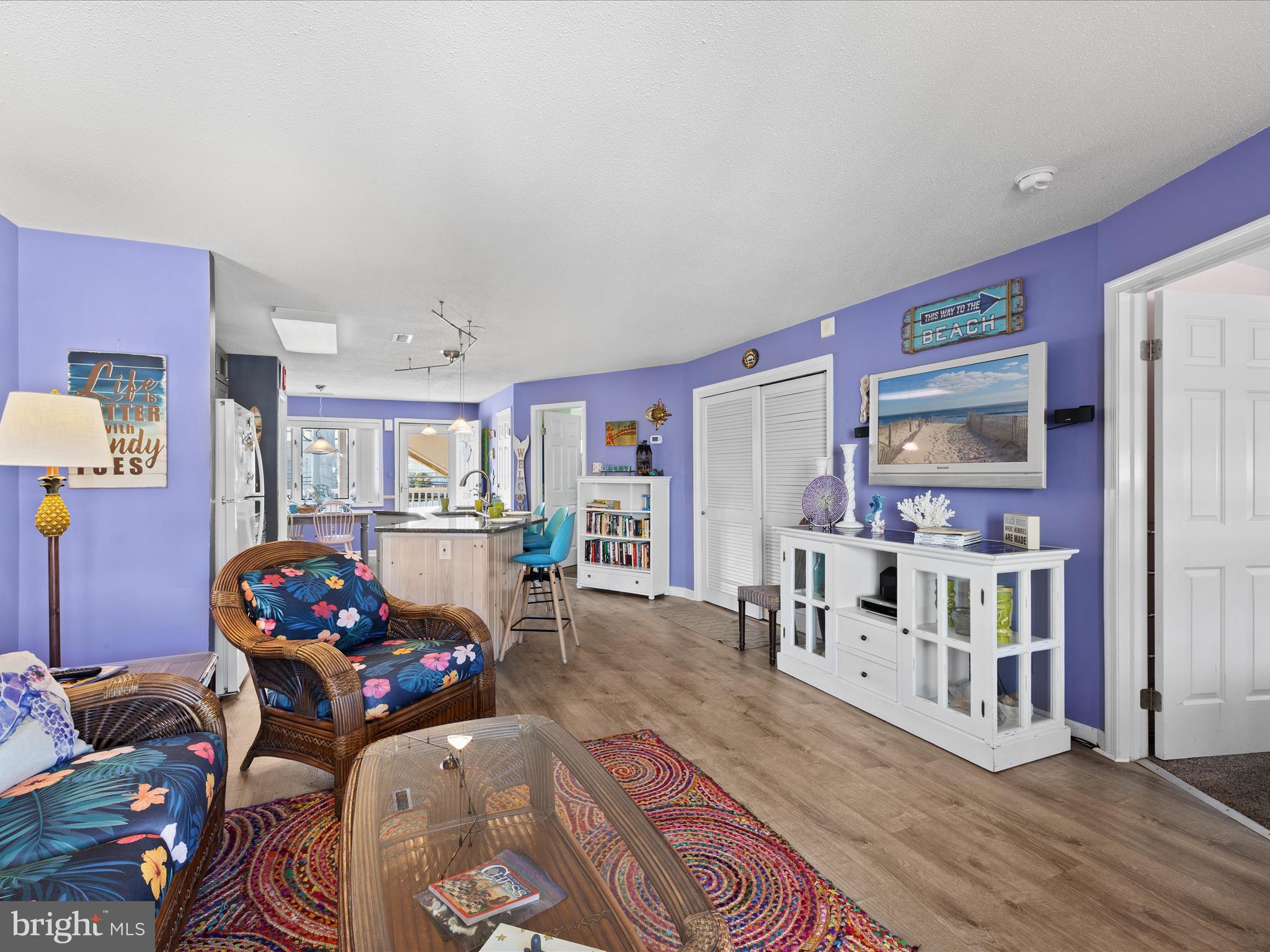 5500 Coastal Highway, Unit B23003 Ocean City, MD 21842 - Photo 12 of 26 a living room with furniture and book shelf
