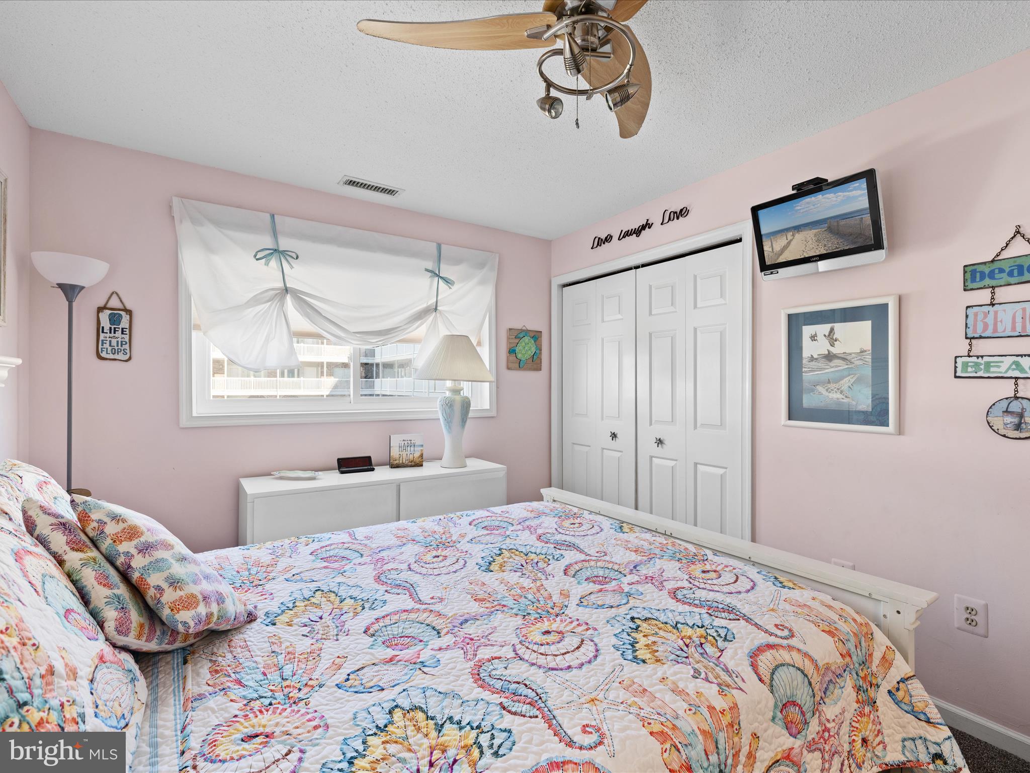 5500 Coastal Highway, Unit B23003 Ocean City, MD 21842 - Photo 14 of 26 a bedroom with a bed and a window