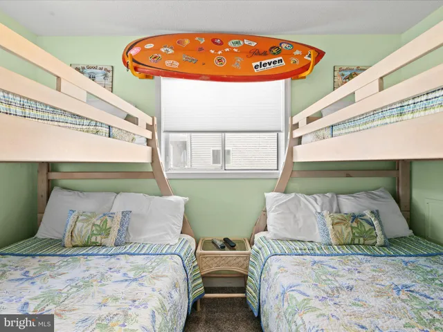 a bedroom with two beds and a window