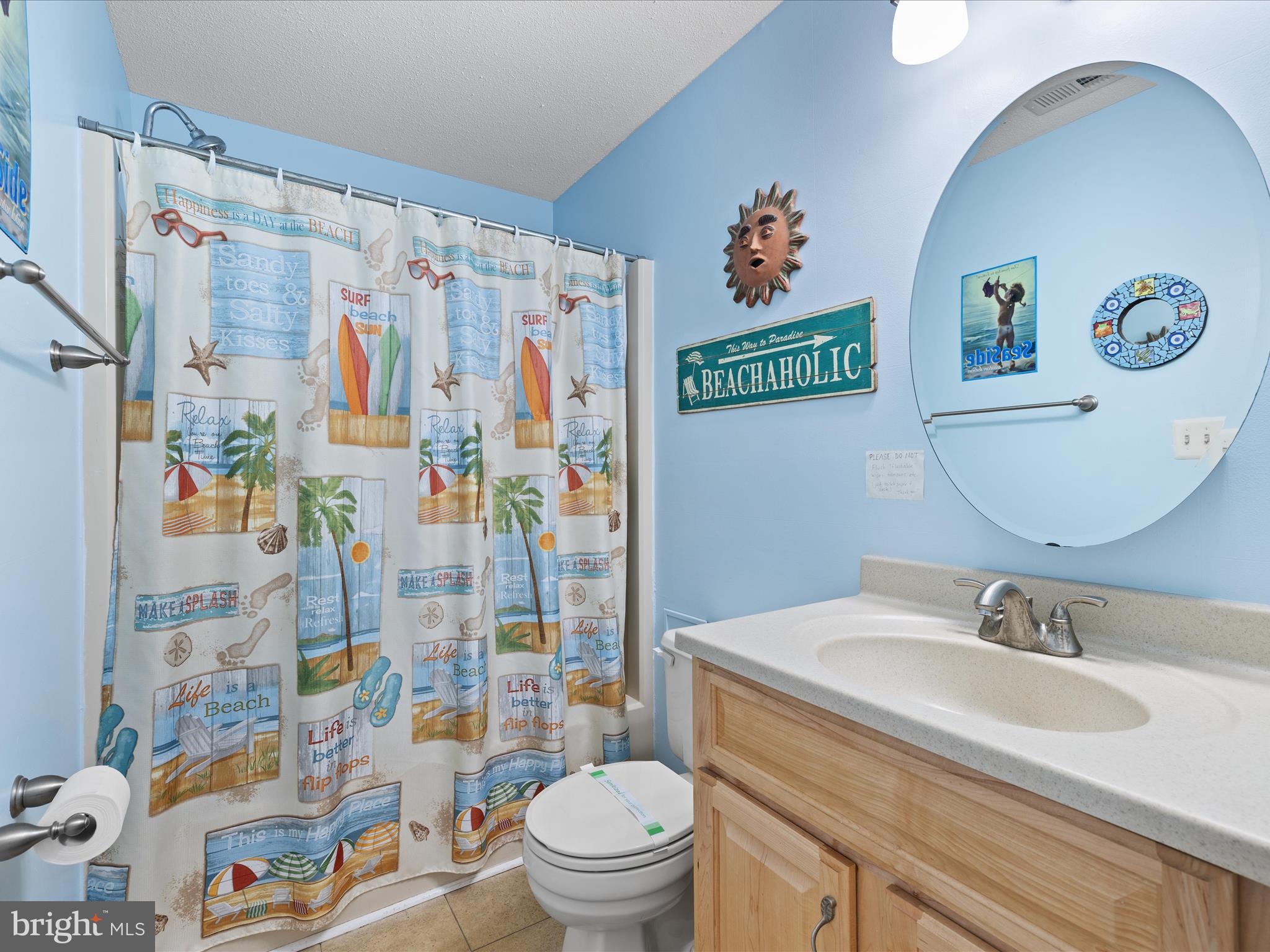 5500 Coastal Highway, Unit B23003 Ocean City, MD 21842 - Photo 19 of 26 a bathroom with a sink toilet and shower