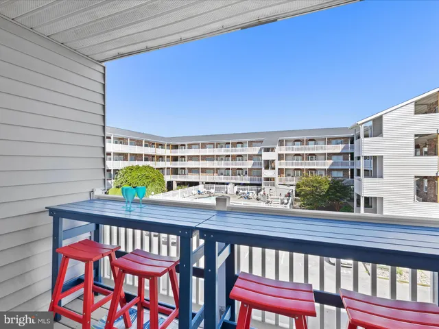 a view of a chairs and table in the balcony