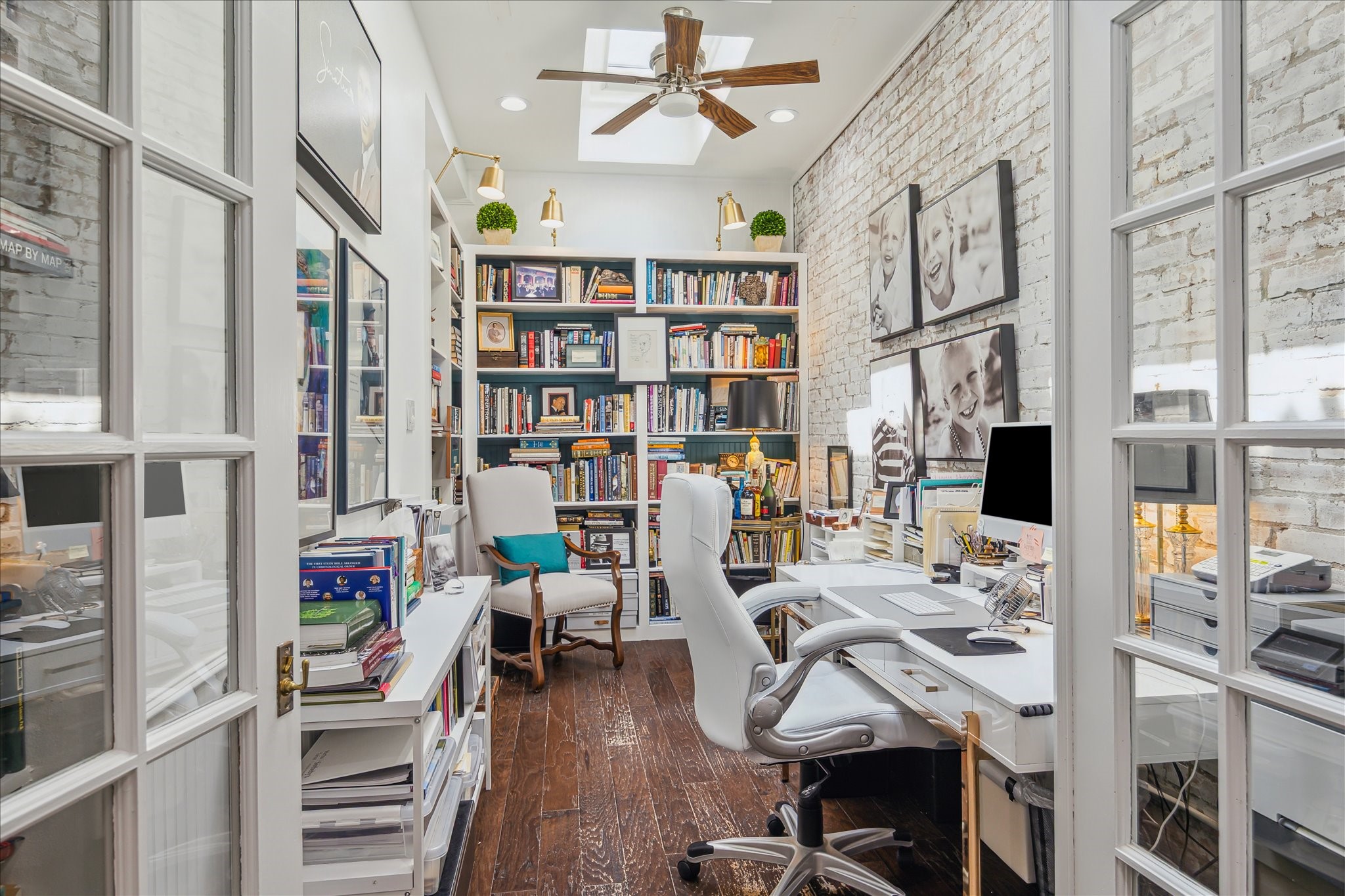 2220 Fulham Court Houston, TX 77063 - Photo 3 of 21 A beautifully lit office retreat featuring a skylight, floor-to-ceiling shelves, and elegant French doors opens gracefully into the dining room — a perfect blend of function and charm.
