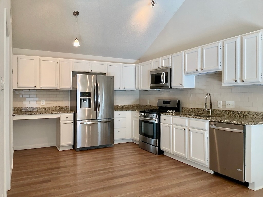 16912 Village Oak Loop Austin, TX 78717 - Photo 7 of 15 a kitchen with a refrigerator stove and wooden cabinets