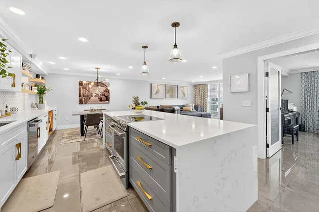 a kitchen with a sink a counter top space stainless steel appliances and cabinets