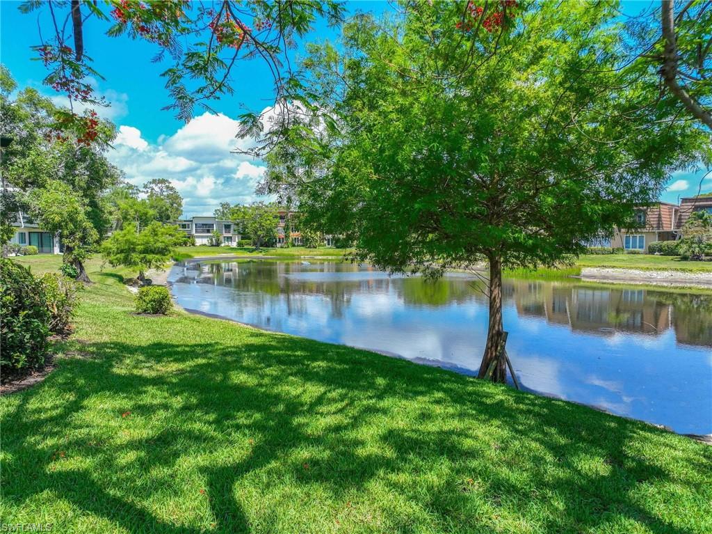 1608 Spoonbill Lane, Unit B Naples, FL 34105 - Photo 21 of 31 a view of a lake with a yard
