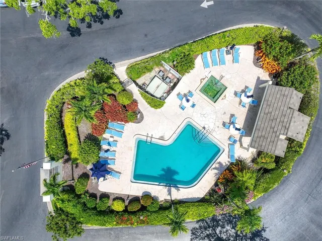 an aerial view of a house a yard and outdoor seating