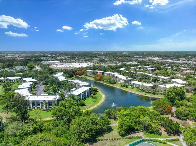 an aerial view of residential houses with outdoor space and river