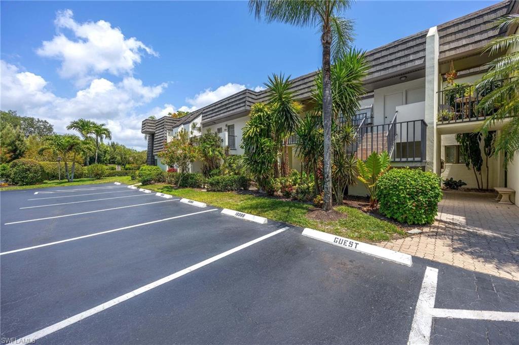 1608 Spoonbill Lane, Unit B Naples, FL 34105 - Photo 29 of 31 a view of a house with a yard and palm trees