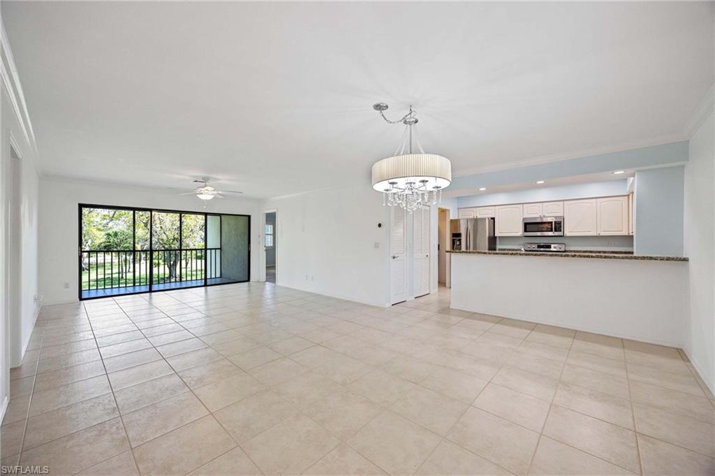 1608 Spoonbill Lane, Unit B Naples, FL 34105 - Photo 4 of 31 a view of an empty room with a window