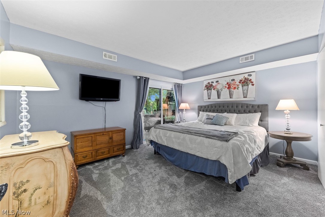 171 Granger Road, Unit 107 Medina, OH 44256 - Photo 29 of 41 Spacious bedroom with light blue walls and gray carpeting