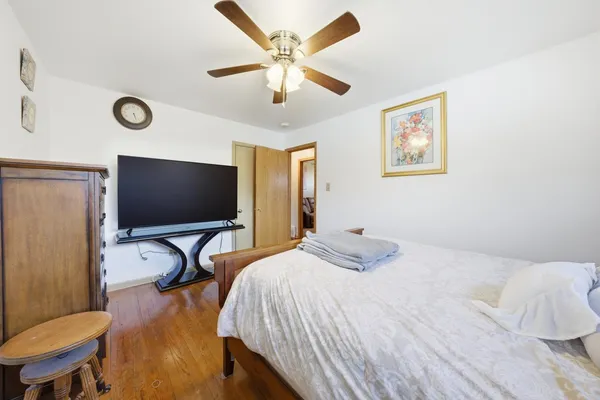 a bedroom with bed and a flat screen tv