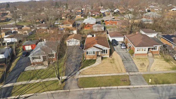 an aerial view of residential houses with outdoor space