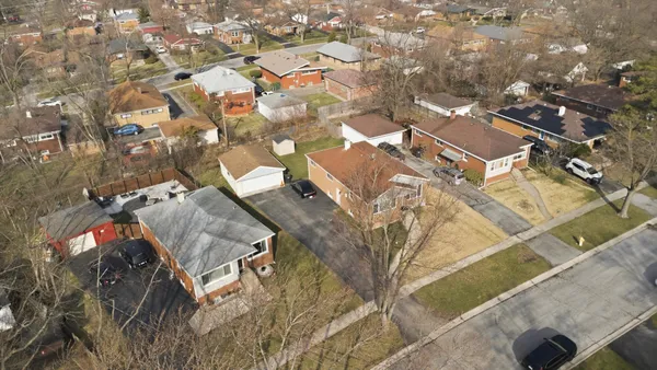 an aerial view of residential houses with outdoor space