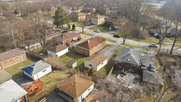 an aerial view of a residential houses with outdoor space