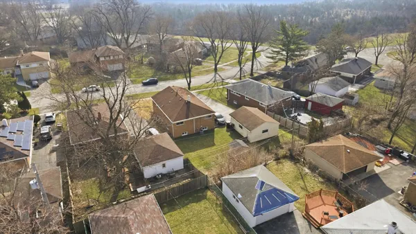 an aerial view of residential house with outdoor space and swimming pool