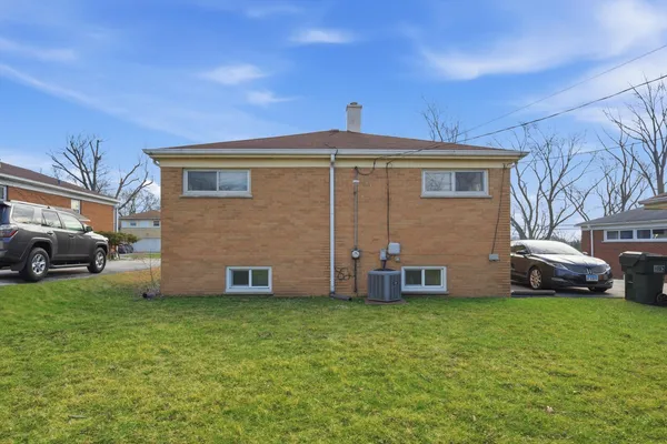 a front view of a house with a garden and yard
