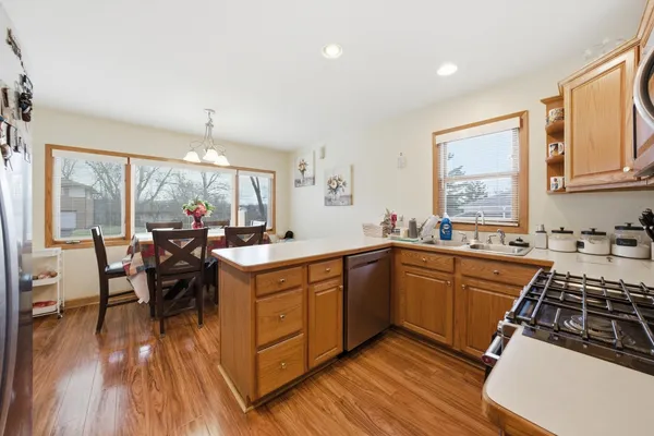 a kitchen with sink cabinets and wooden floor