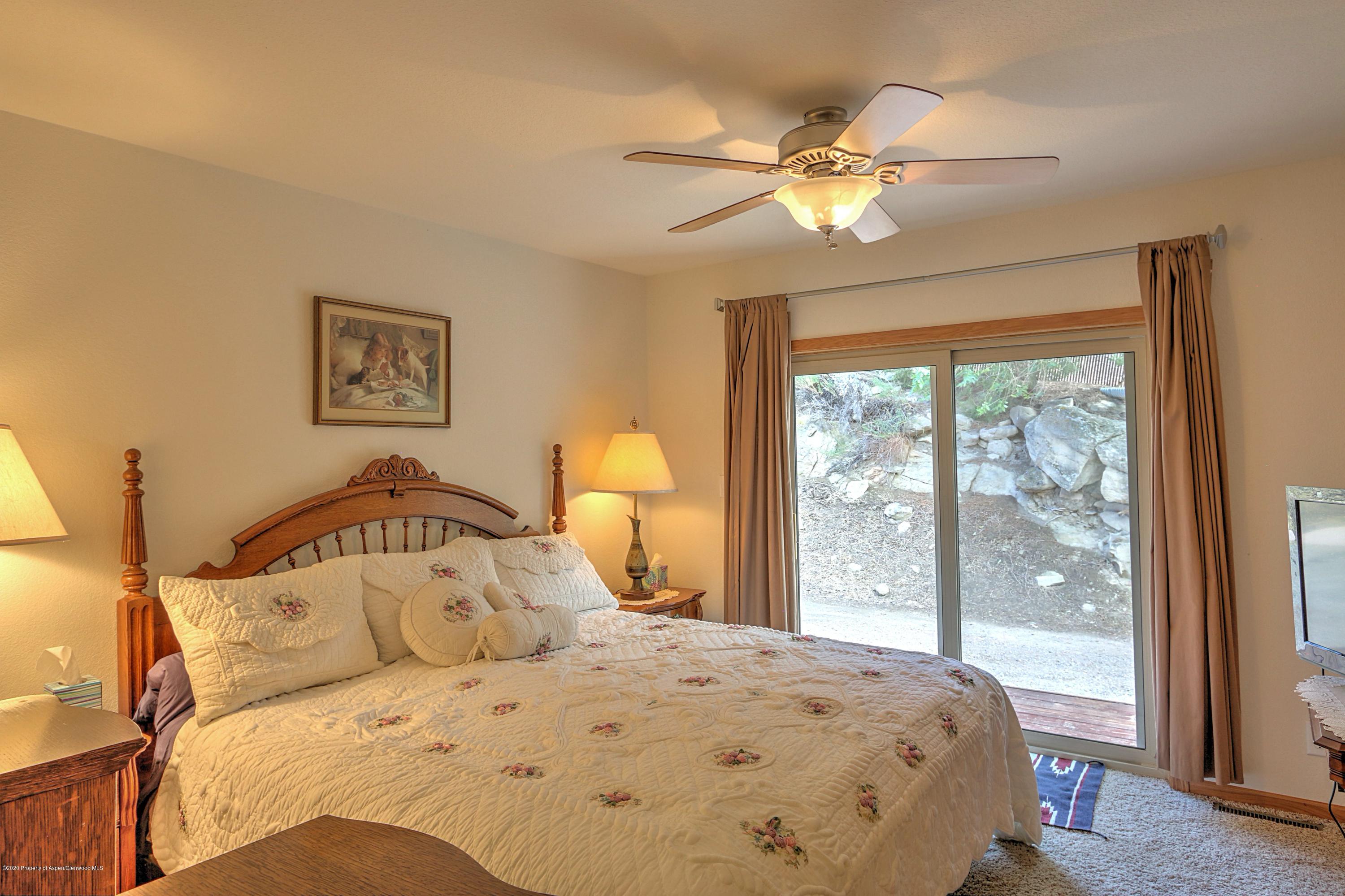 3045 Highway 325 Rifle, CO 81650 - Photo 12 of 35 a bedroom with a large bed and a window