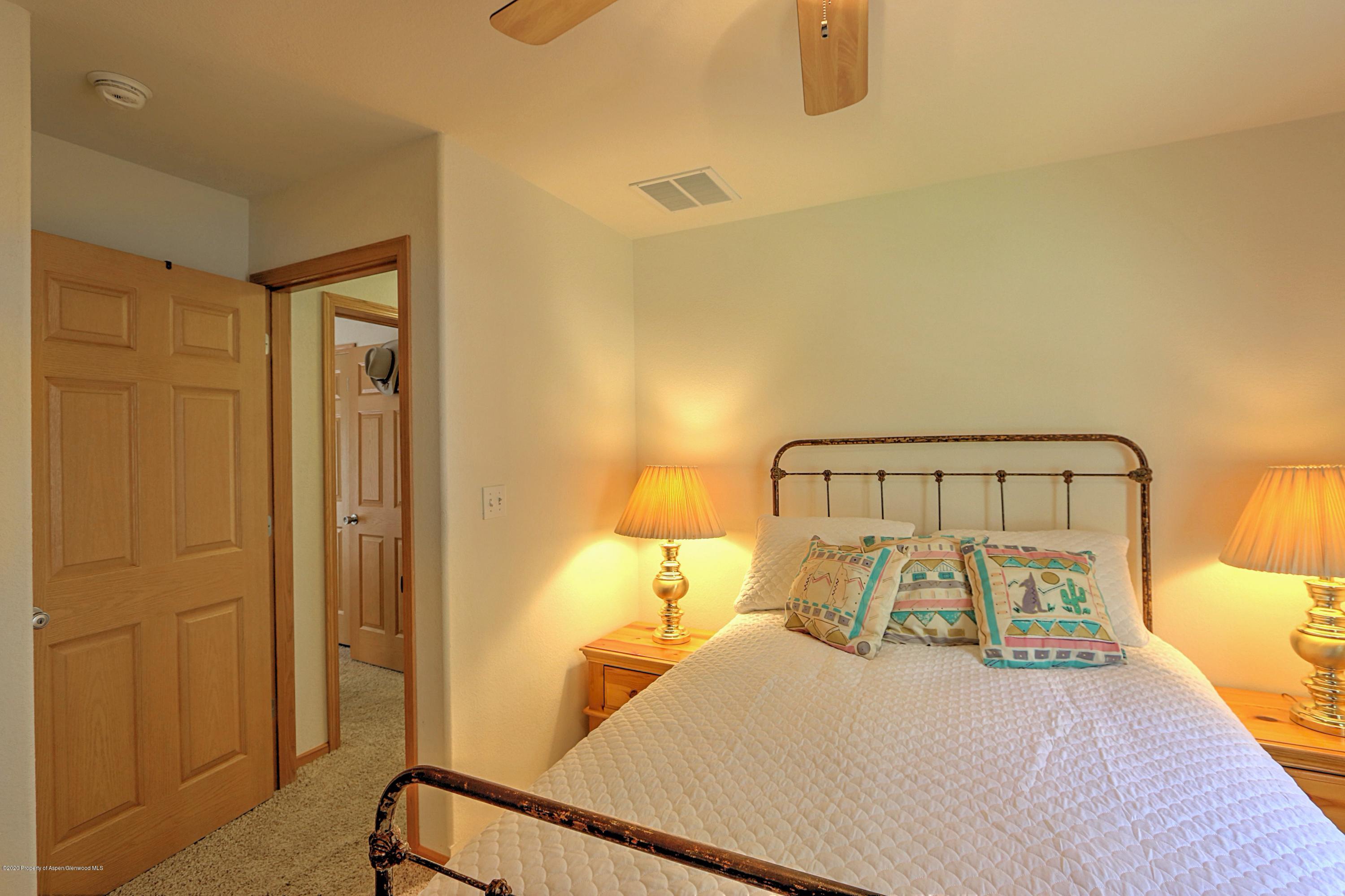 3045 Highway 325 Rifle, CO 81650 - Photo 14 of 35 a bedroom with a bed and a night stand